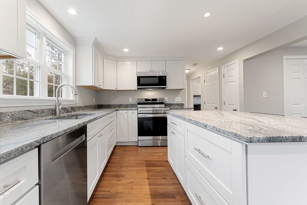 1069 Main Street Dunstable, MA 01827 - Photo 12 of 41 a kitchen with granite countertop stainless steel appliances and white cabinets