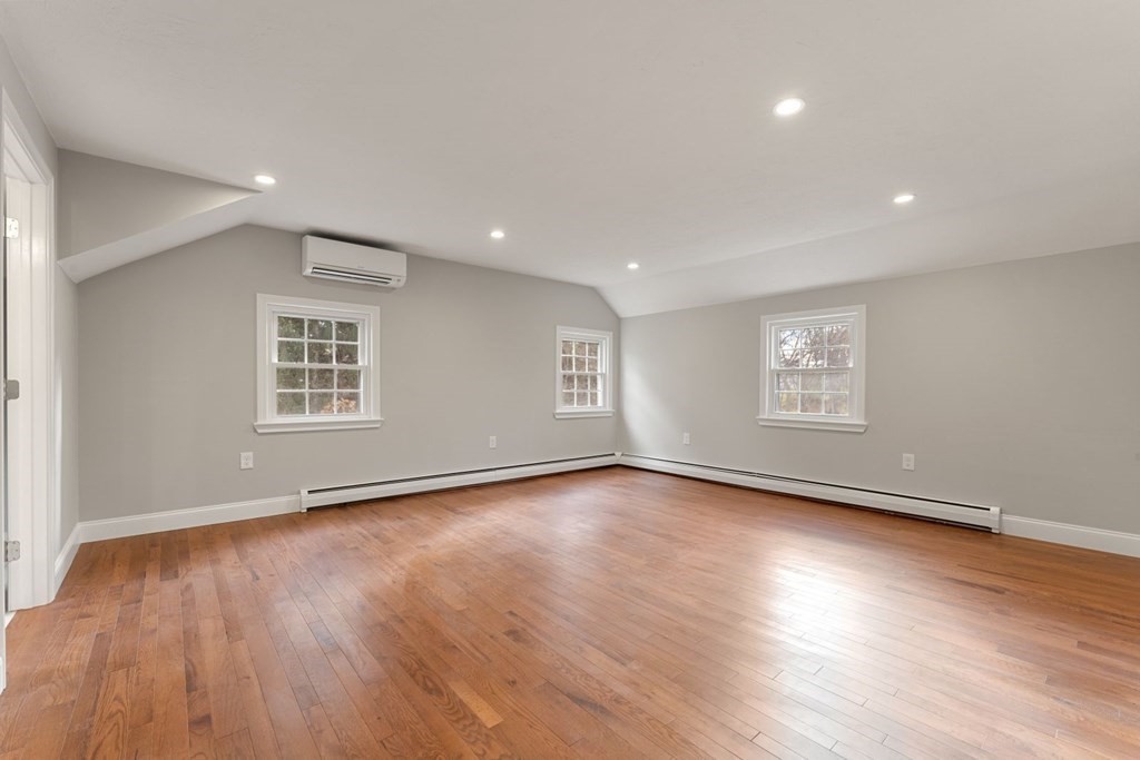 1069 Main Street Dunstable, MA 01827 - Photo 23 of 41 an empty room with wooden floor and windows