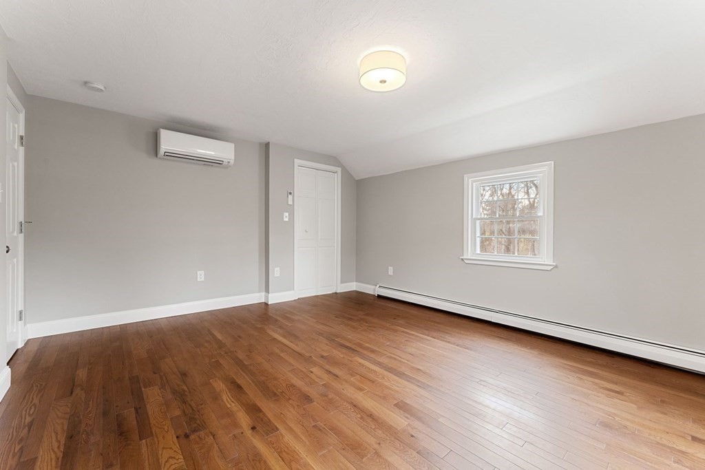 1069 Main Street Dunstable, MA 01827 - Photo 26 of 41 an empty room with wooden floor and windows