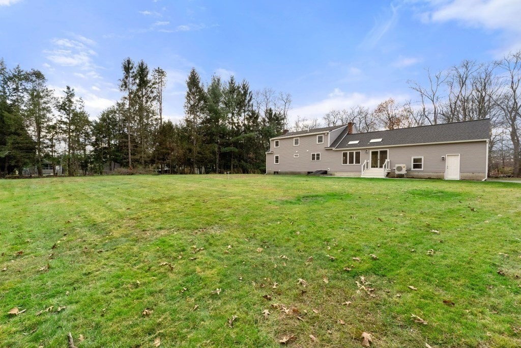 1069 Main Street Dunstable, MA 01827 - Photo 33 of 41 a view of a house with backyard and trees