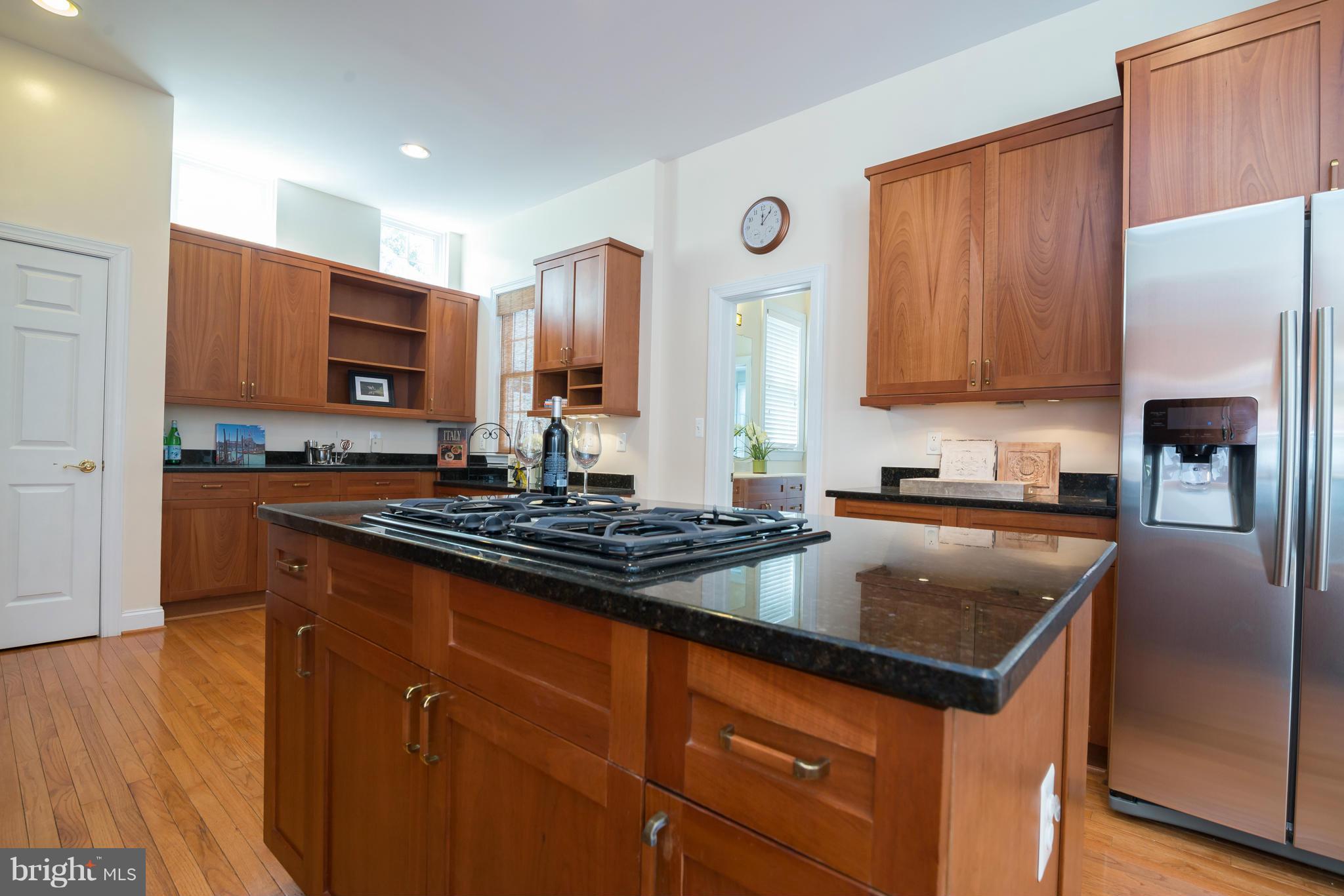 831 Woodside Parkway Silver Spring, MD 20910 - Photo 10 of 30 a kitchen with stainless steel appliances granite countertop a stove a sink and a refrigerator