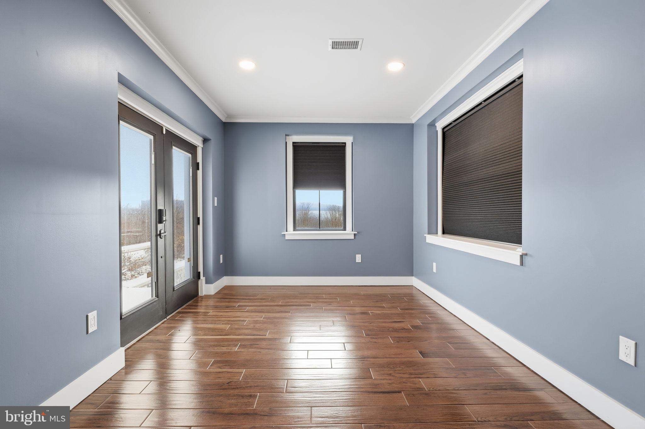 176 Fenstermaker Road Kutztown, PA 19530 - Photo 104 of 149 an empty room with wooden floor and windows