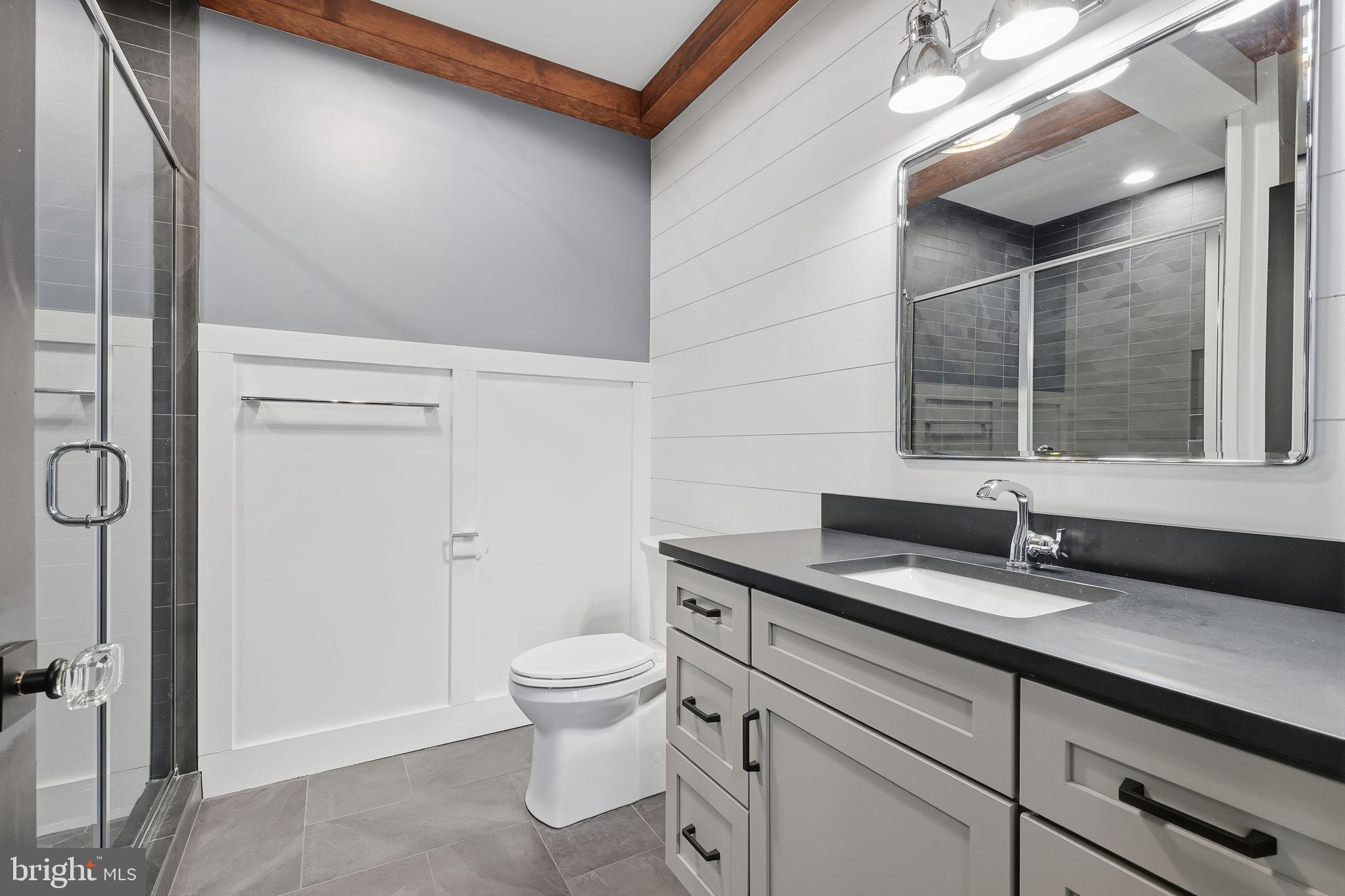 176 Fenstermaker Road Kutztown, PA 19530 - Photo 106 of 149 a bathroom with a granite countertop sink a toilet and a mirror