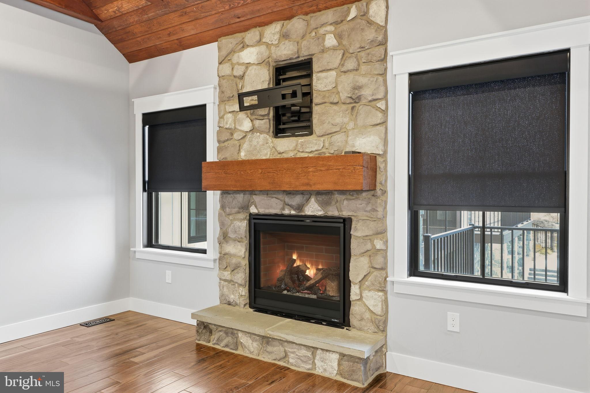 176 Fenstermaker Road Kutztown, PA 19530 - Photo 115 of 149 Cozy stone fireplace in a modern setting.