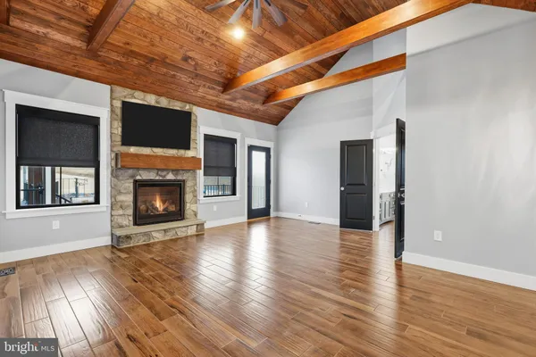 a living room with furniture and view of kitchen