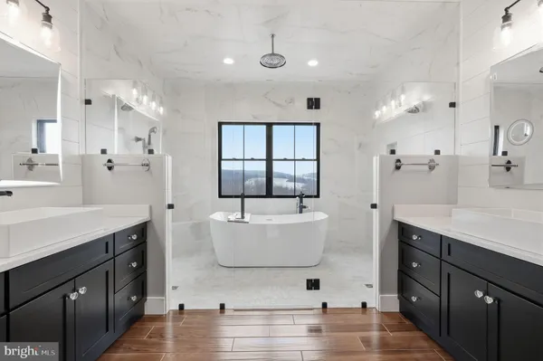 a kitchen with kitchen island a large counter top space a sink stainless steel appliances and cabinets