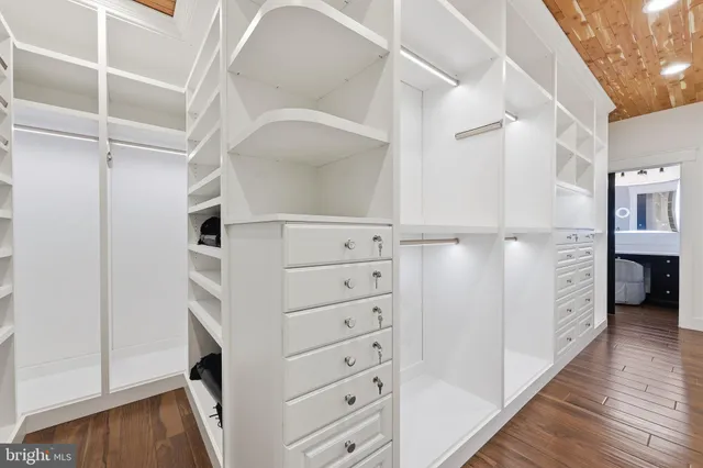 a bathroom with a granite countertop sink mirror vanity and toilet