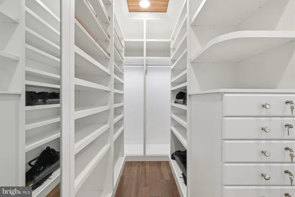 a bedroom with a large bed and a ceiling fan