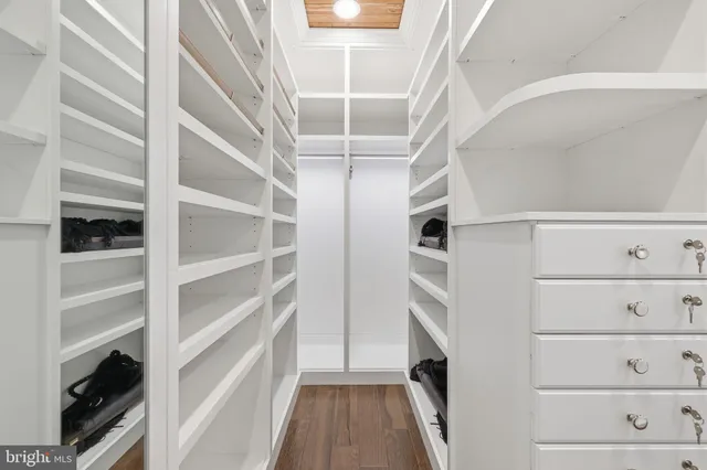 a bedroom with a large bed and a ceiling fan