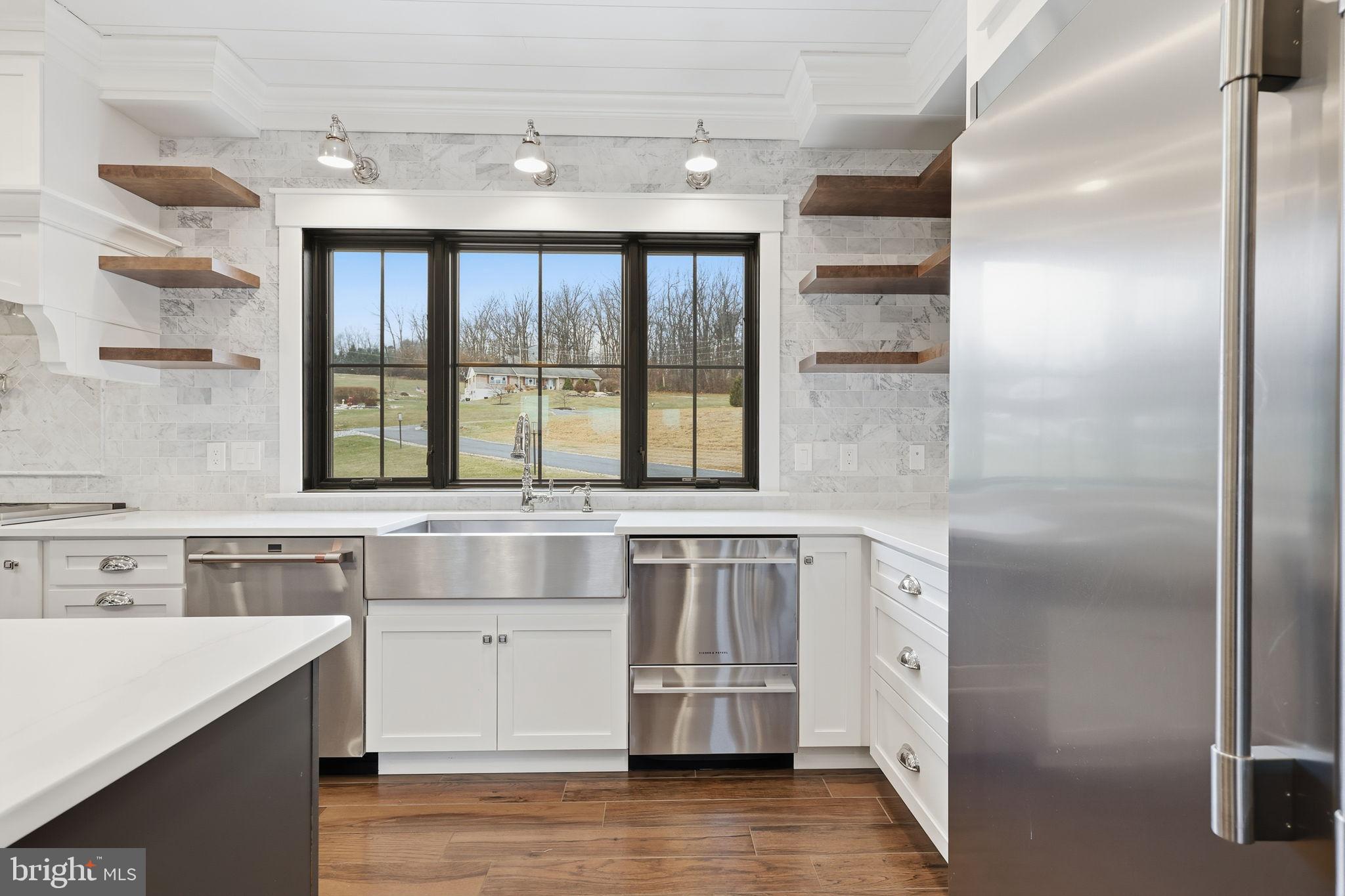 176 Fenstermaker Road Kutztown, PA 19530 - Photo 49 of 149 a kitchen with stainless steel appliances granite countertop a sink and cabinets with wooden floor