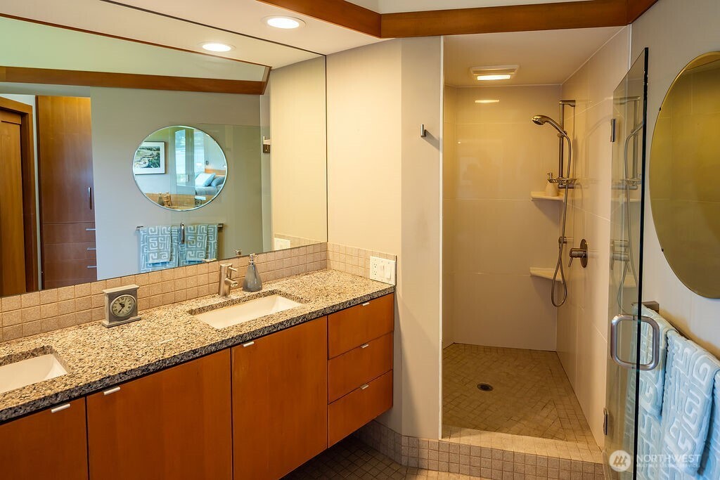 2000 Bayshore Road Lopez Island, WA 98261 - Photo 25 of 40 a bathroom with a granite countertop sink mirror and a shower