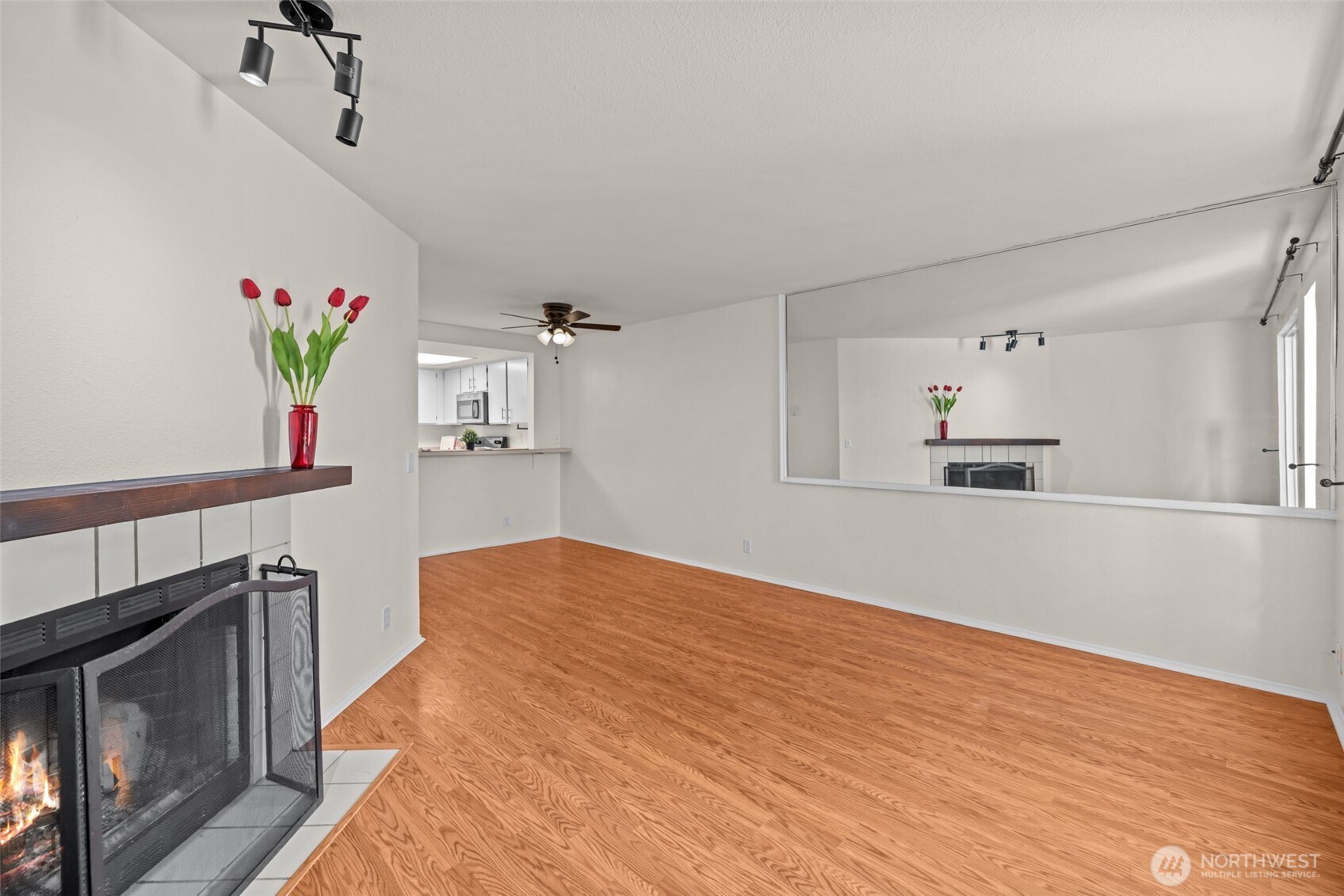 8512 242nd Street Southwest, Unit 3 Edmonds, WA 98026 - Photo 11 of 32 a view of empty room with wooden floor and fan