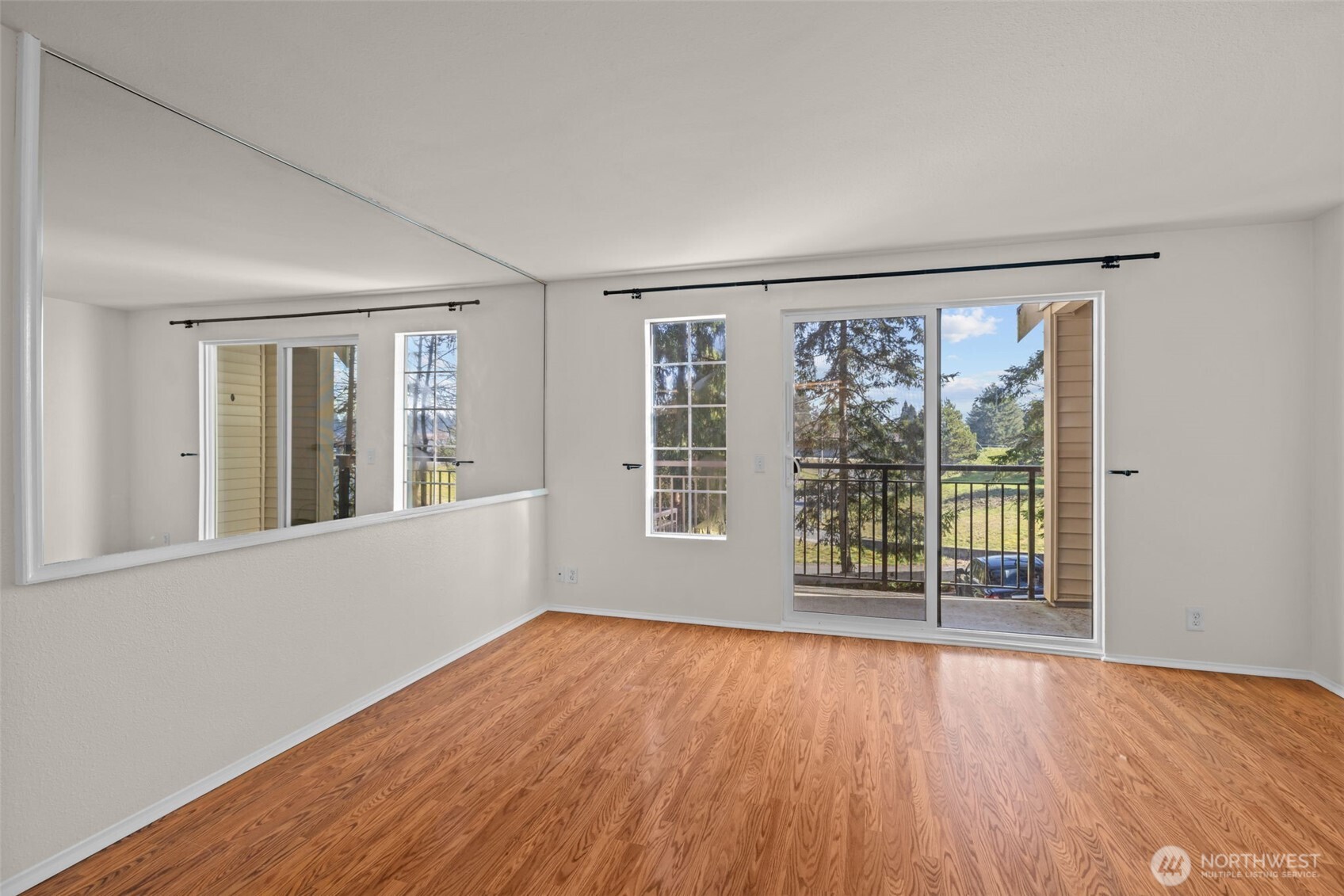 8512 242nd Street Southwest, Unit 3 Edmonds, WA 98026 - Photo 12 of 32 a view of an empty room with wooden floor and a window