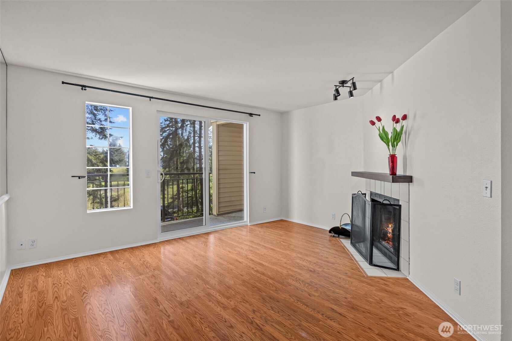 8512 242nd Street Southwest, Unit 3 Edmonds, WA 98026 - Photo 13 of 32 a view of an empty room with a window and fireplace