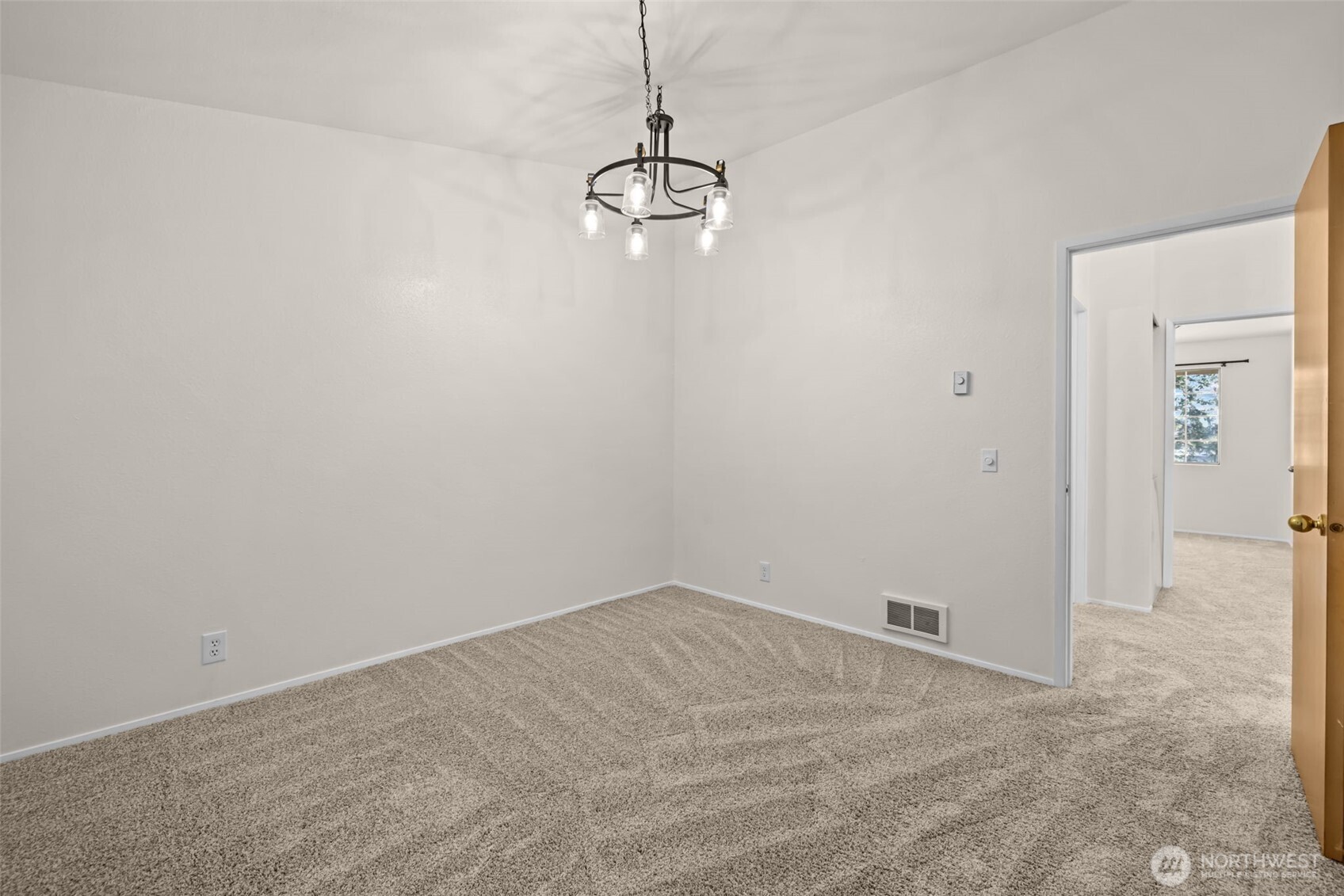 8512 242nd Street Southwest, Unit 3 Edmonds, WA 98026 - Photo 18 of 32 a view of a room with a hanging light and kitchen view