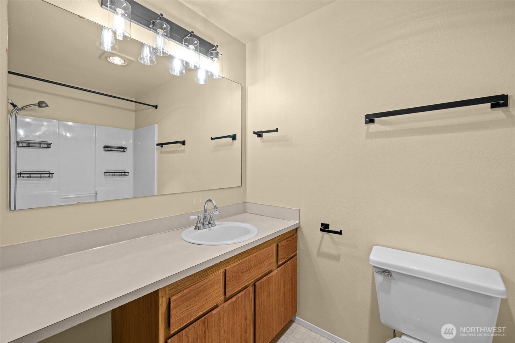 8512 242nd Street Southwest, Unit 3 Edmonds, WA 98026 - Photo 19 of 32 a bathroom with a sink a toilet and shower