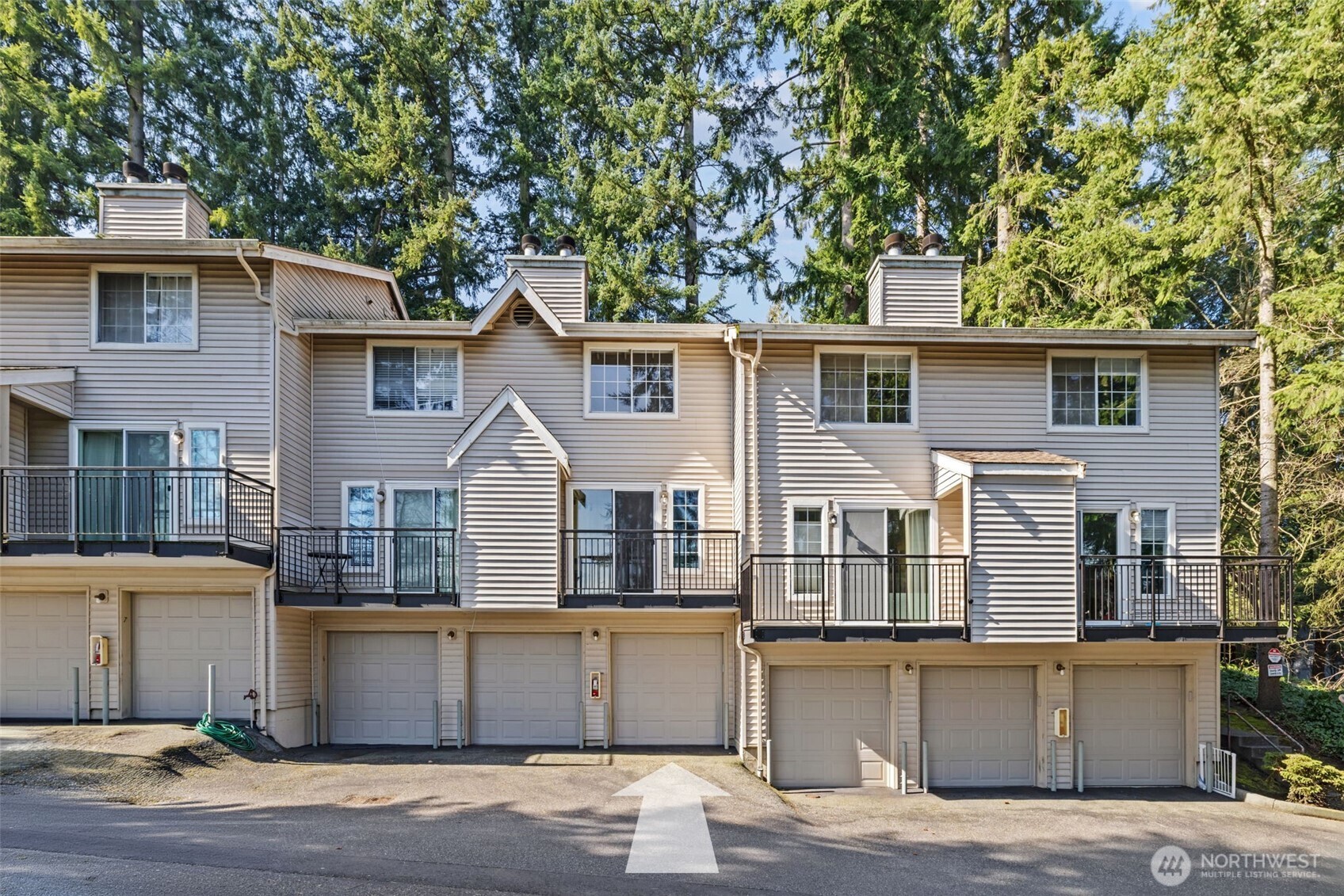 8512 242nd Street Southwest, Unit 3 Edmonds, WA 98026 - Photo 28 of 32 a front view of a house with a yard and trees