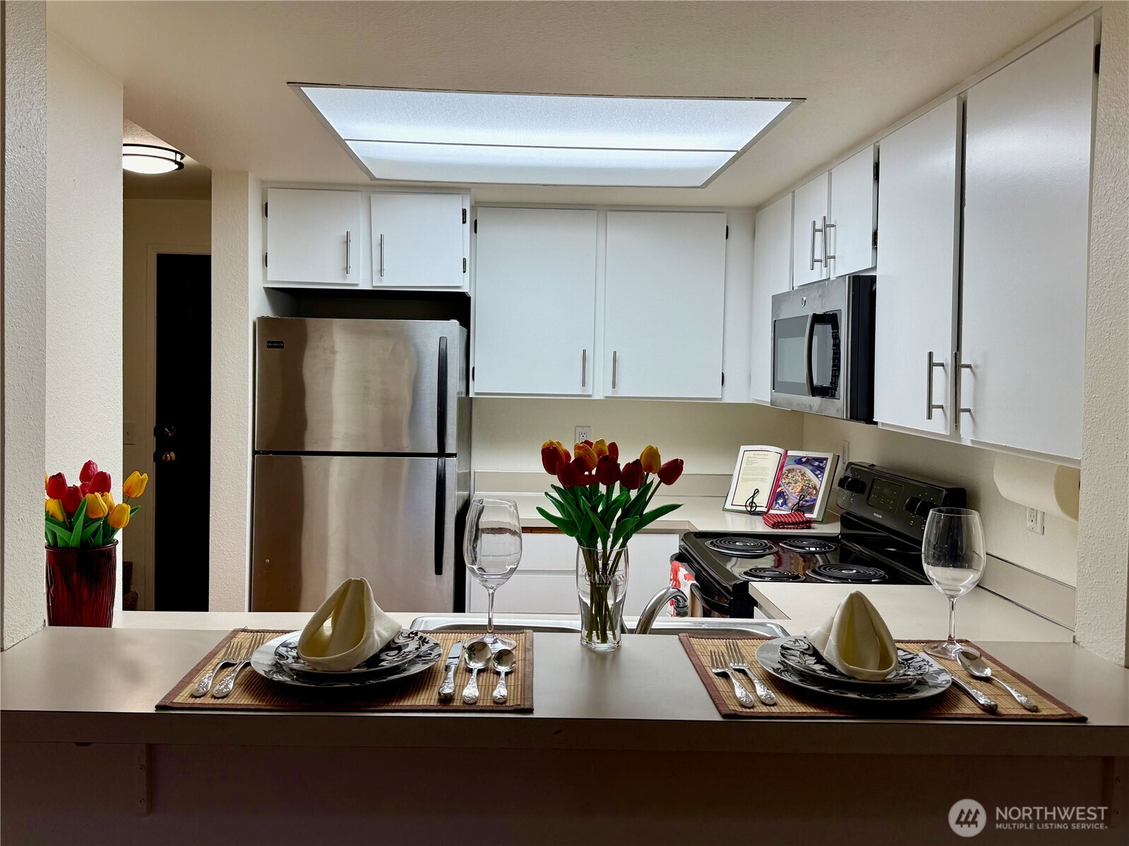 8512 242nd Street Southwest, Unit 3 Edmonds, WA 98026 - Photo 5 of 32 a kitchen with a refrigerator and a stove