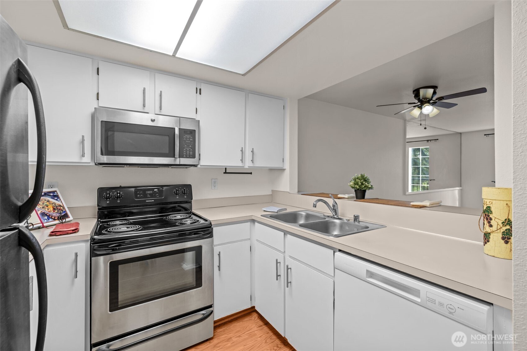 8512 242nd Street Southwest, Unit 3 Edmonds, WA 98026 - Photo 6 of 32 a kitchen with cabinets stainless steel appliances a sink and a counter space