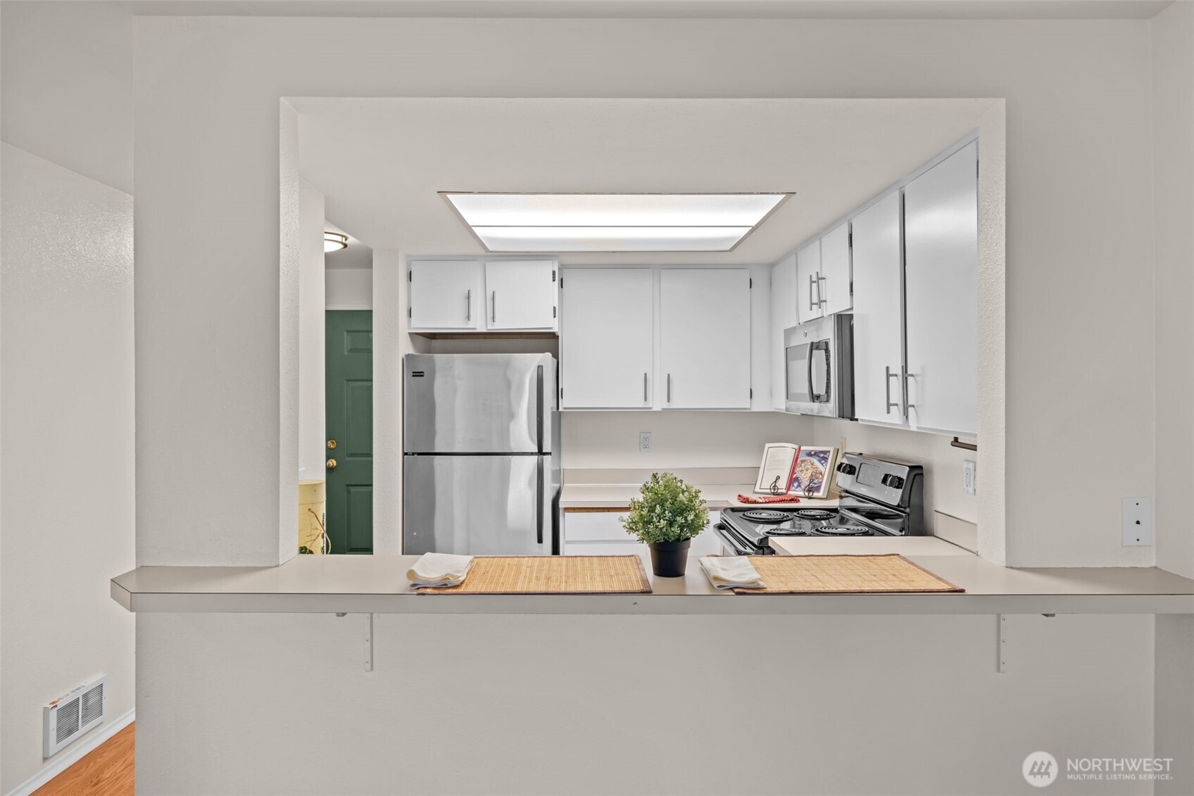 8512 242nd Street Southwest, Unit 3 Edmonds, WA 98026 - Photo 7 of 32 a kitchen with kitchen island a counter top space and stainless steel appliances
