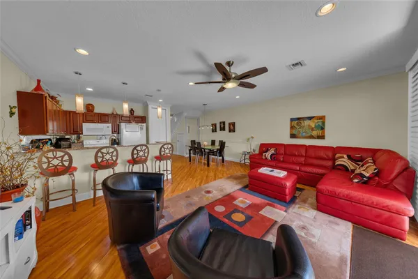 a living room with furniture and a view of kitchen