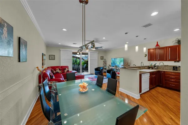 a living room with dining room and kitchen view