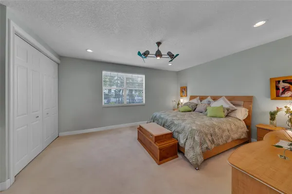 a spacious bedroom with two beds and a window