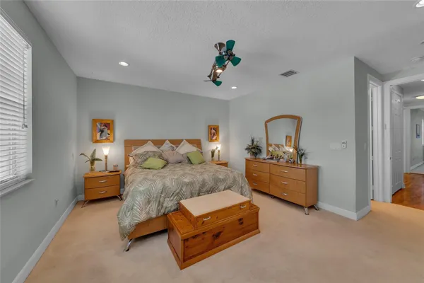 a bedroom with a bed couch and window