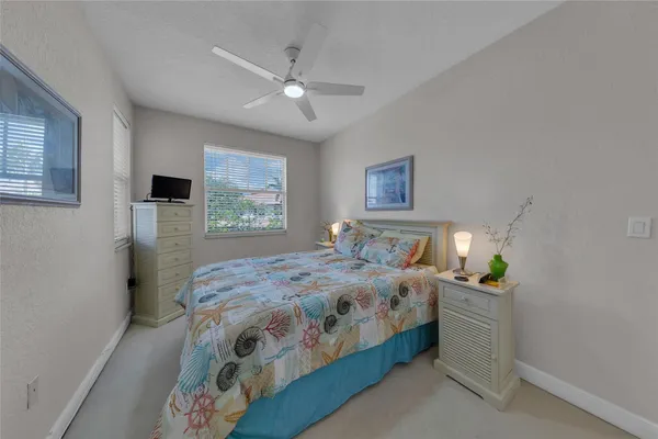 a bedroom with a bed a dresser and a window