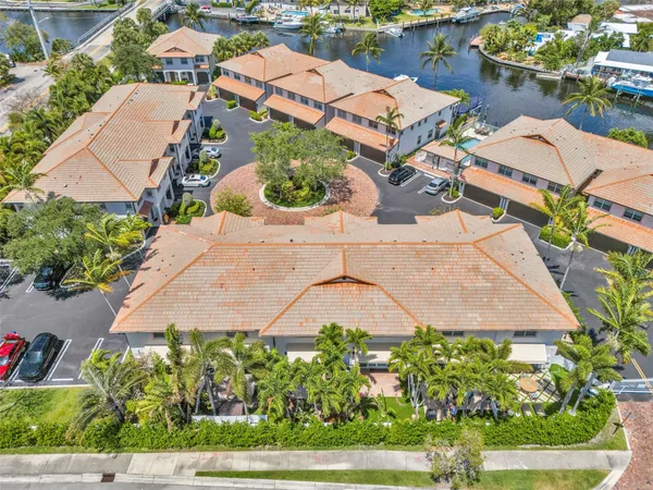 an aerial view of a house with a garden and lake view