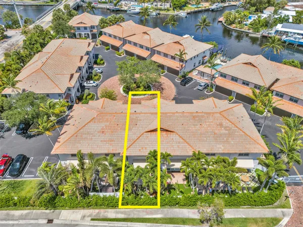 an aerial view of a house with a yard and lake view