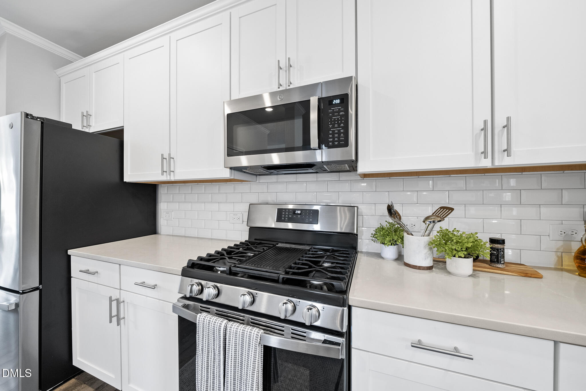 3836 Mason Blf Drive Raleigh, NC 27616 - Photo 11 of 37 a kitchen with stainless steel appliances white cabinets and a stove a oven