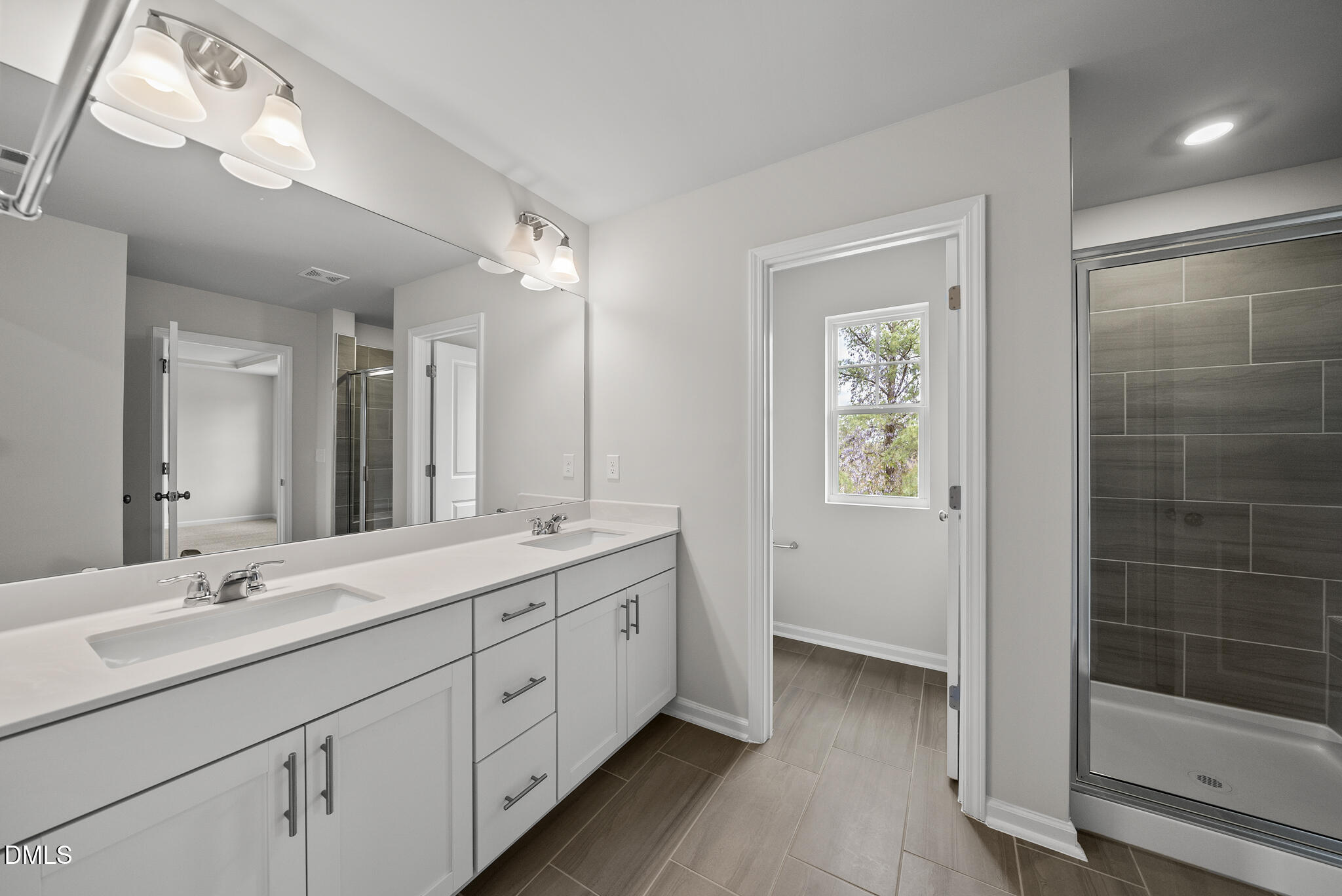 3836 Mason Blf Drive Raleigh, NC 27616 - Photo 26 of 37 a bathroom with double sink and a mirror