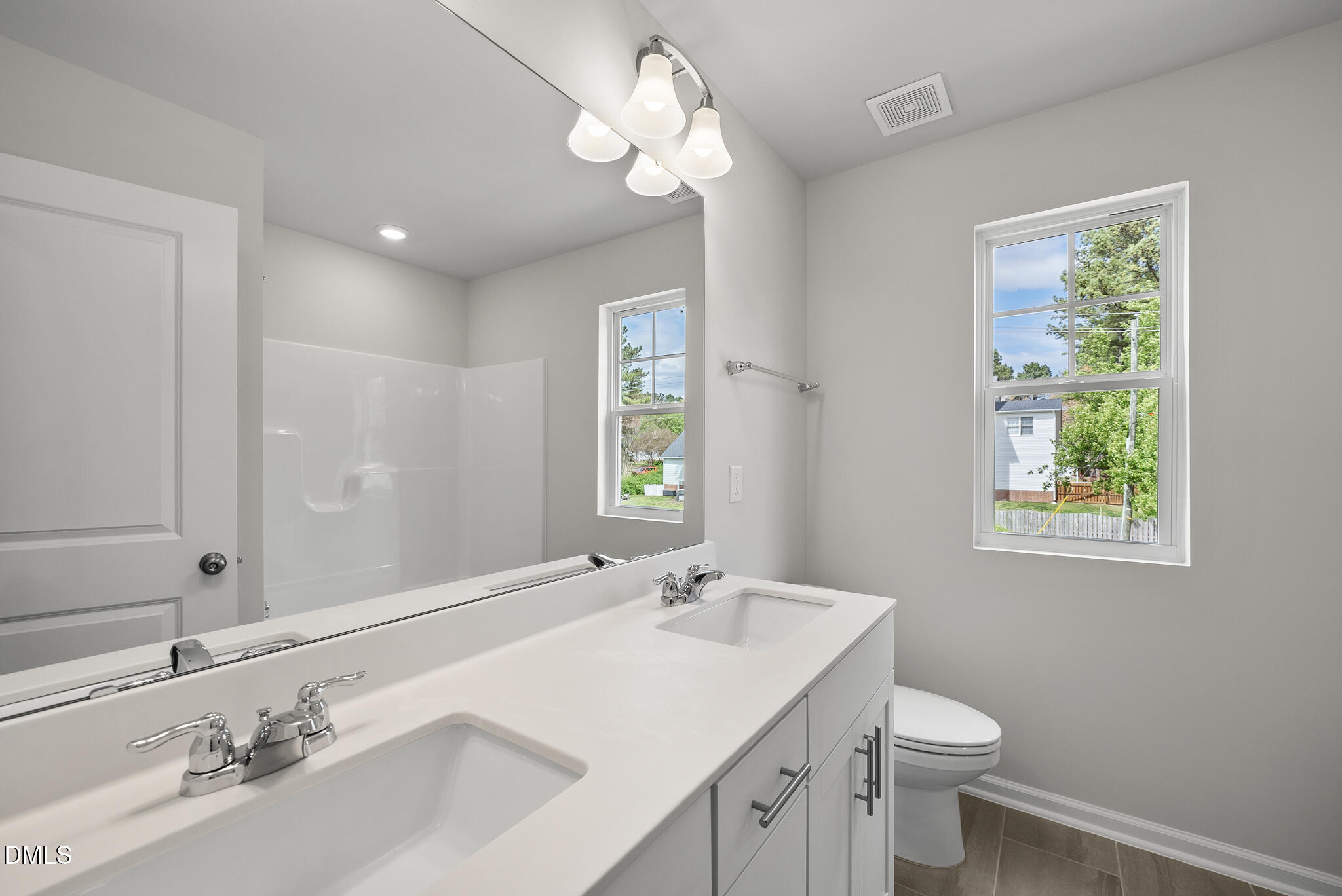 3836 Mason Blf Drive Raleigh, NC 27616 - Photo 31 of 37 a bathroom with a sink a toilet and a mirror