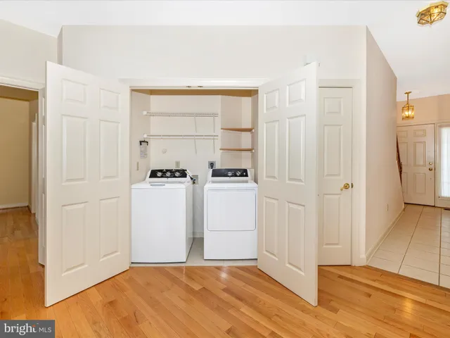 a view of a livingroom with kitchen appliances and cabinets