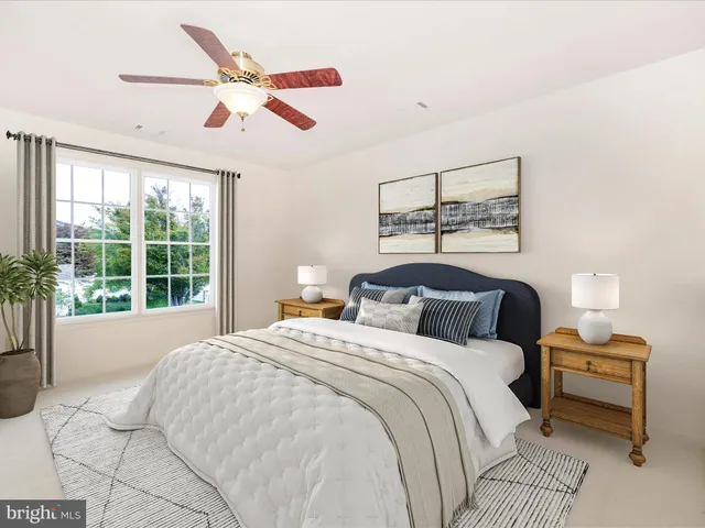 a bedroom with a large bed and a large window