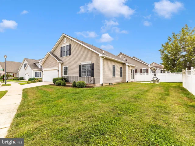 a view of a house with a yard patio and swimming pool