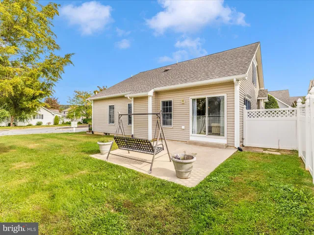 a view of a house with backyard porch and sitting area
