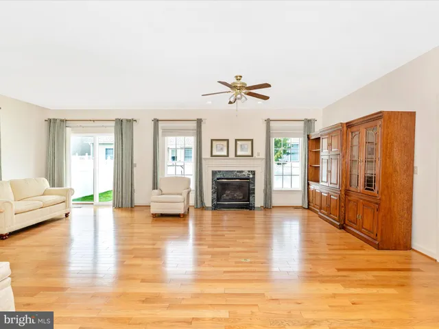 a view of a livingroom with furniture fireplace and wooden floor