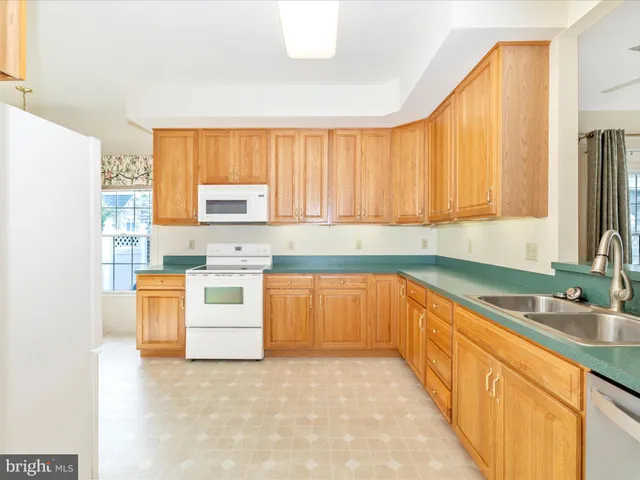 a kitchen with stainless steel appliances a stove sink and cabinets