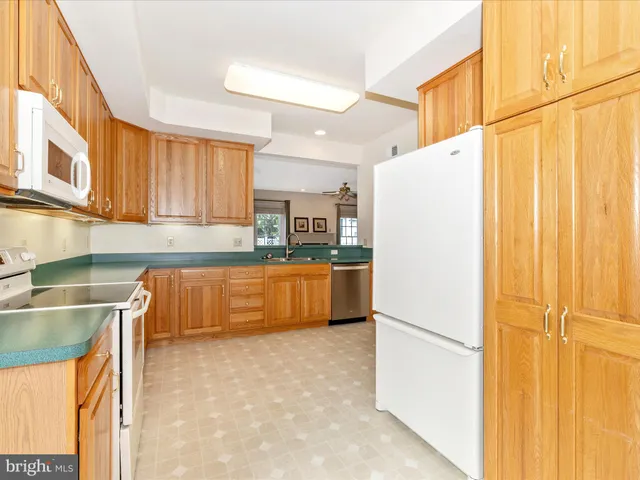 a kitchen with a refrigerator a sink and cabinets