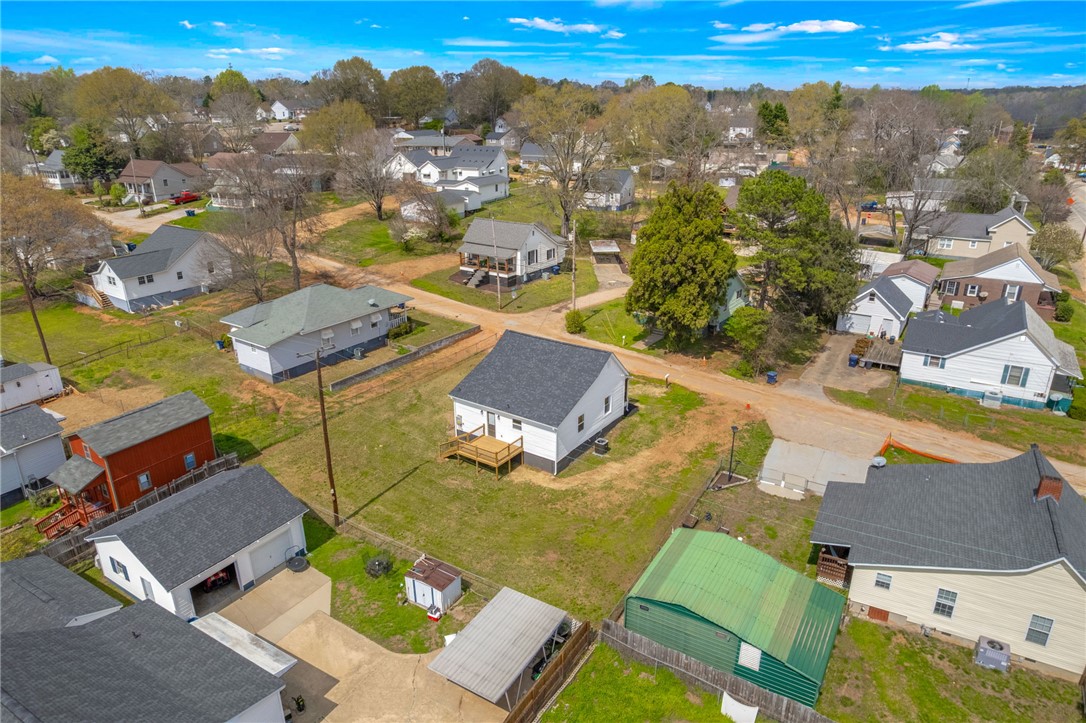 2 Allen Street Pelzer, SC 29669 - Photo 20 of 25 An aerial perspective reveals a vibrant neighborhood with diverse homes under a bright sky.