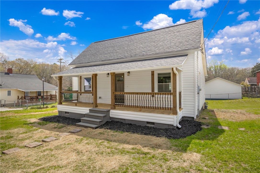 2 Allen Street Pelzer, SC 29669 - Photo 2 of 25 This charming home features a welcoming porch, offering a comfortable outdoor living space.
