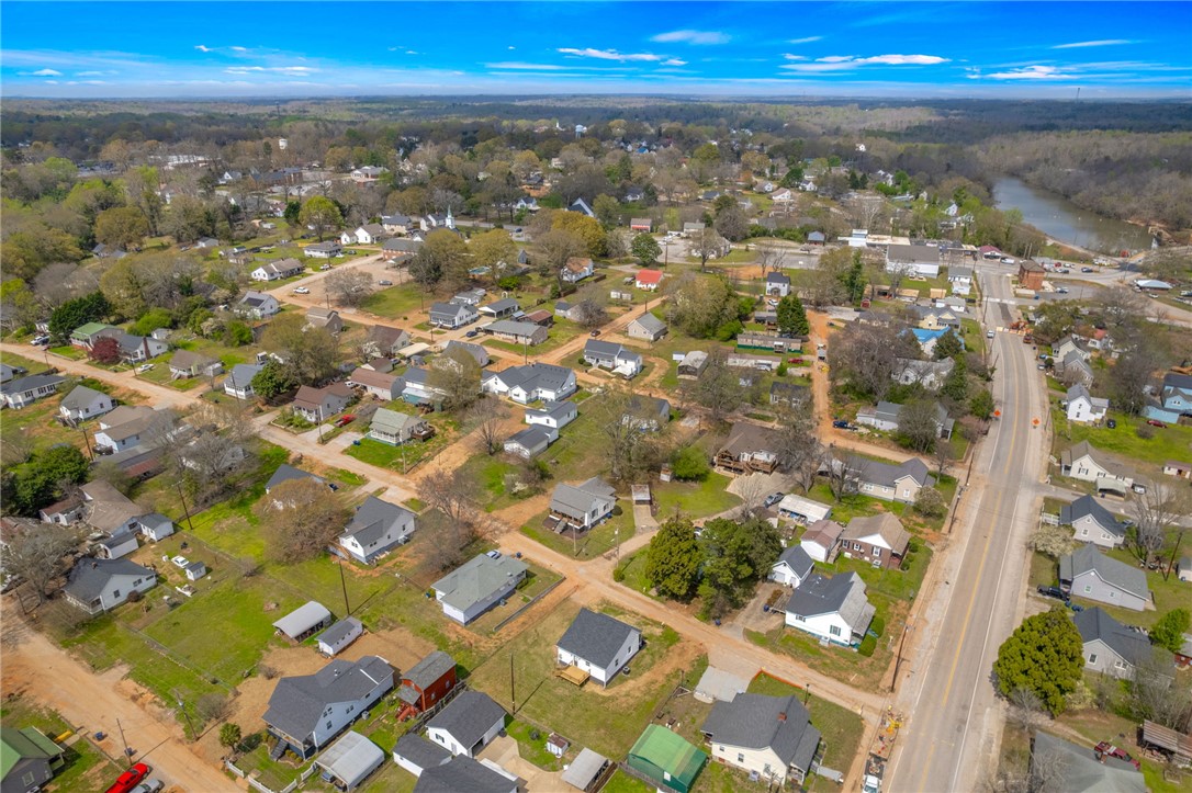 2 Allen Street Pelzer, SC 29669 - Photo 24 of 25 An inviting aerial view reveals a charming community nestled amidst lush greenery and winding roads.