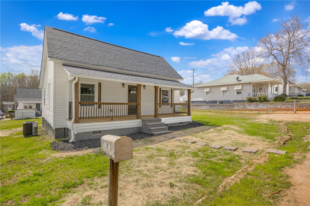 2 Allen Street Pelzer, SC 29669 - Photo 3 of 25 This charming home offers a welcoming facade with a covered porch and traditional siding.