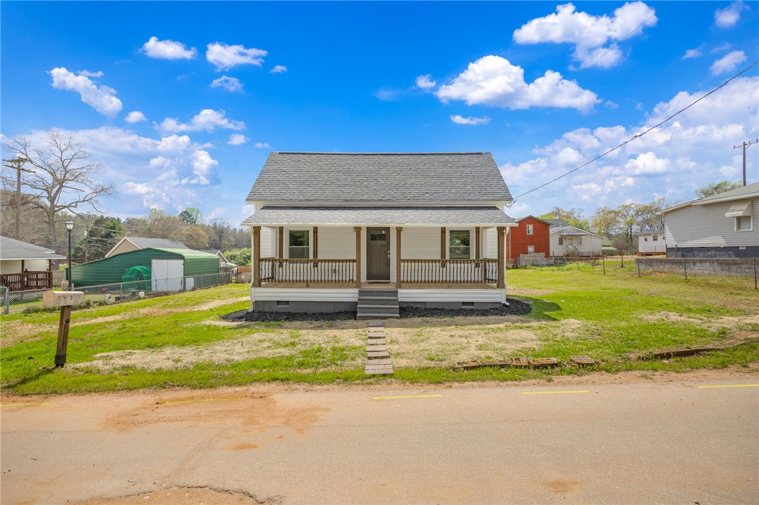 2 Allen Street Pelzer, SC 29669 - Photo 4 of 25 This charming home features a welcoming porch, perfect for relaxing outdoors.