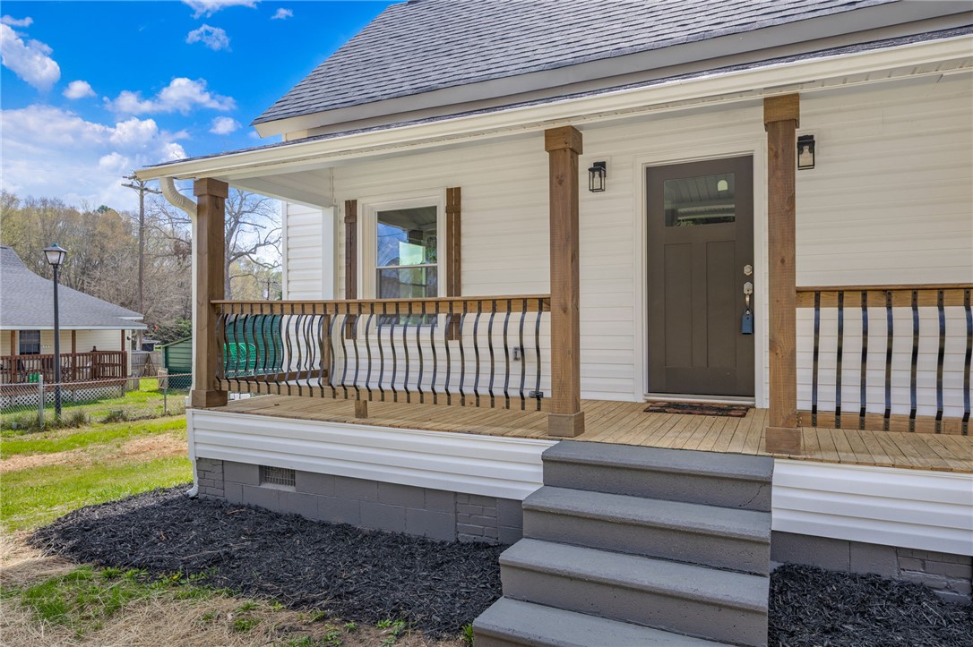 2 Allen Street Pelzer, SC 29669 - Photo 5 of 25 This inviting home features a charming porch, perfect for enjoying peaceful moments outdoors.