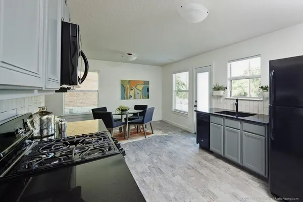 a kitchen with a stove a sink and a refrigerator