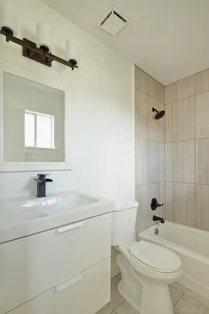 a bathroom with a sink a toilet and a mirror