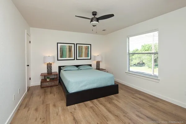 a living room with a bed furniture and a window